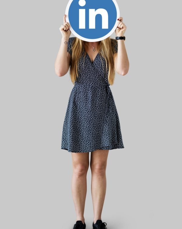 Woman holding a Linkedin icon